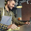 Waiter cleaning bar counter before work